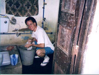 American guy washing clothes by hand in India
