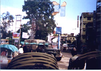 A regular all-mixed-up street scene taken from a rickshaw rider's vantage point in India.